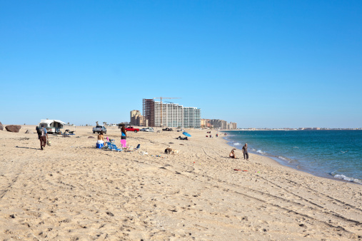 Puerto Penasco, Mexico - November 26, 2011: People on Sandy Beach in Puerto Penasco, Mexico also known as Rocky Point. Many new hotels are going up on this beach and tourism is increasing in this area.