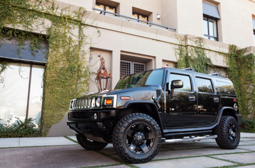 Scottsdale, United States - January 25, 2012: A photo of a parked black Hummer H2. The H2 is the predecessor to the well known military used Hummer H1.