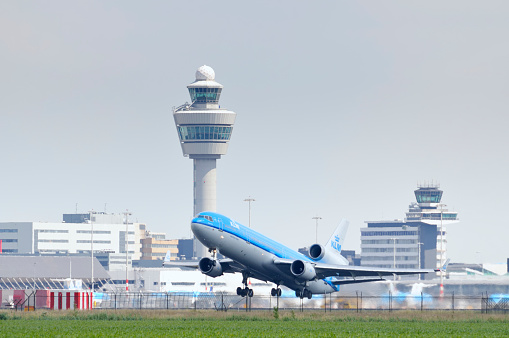 Schiphol, The Netherlands - June 12, 2011: KLM McDonnell Douglas MD11 airplane taking off from Schiphol Airport in The Netherlands.