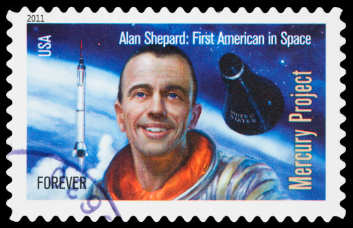 Sacramento, California, USA - September 27, 2011: A 2011 United States postage stamp with an illustration of Alan Shepard (1923-1998), and a Mercury capsule and Redstone rocket in the background. Shepard became the first USA astronaut to be launched into space during a suborbital flight in the Mercury Project spacecraft Freedom 7, on May 5, 1961.