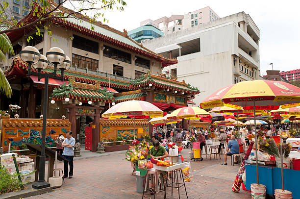 Cozy street cafe with wooden furniture under sun umbrellas.