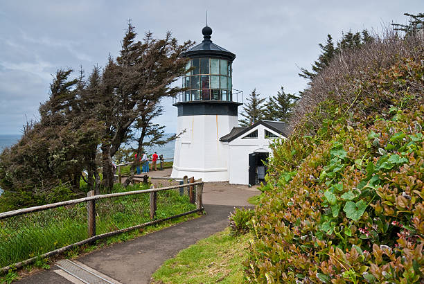 Visitors at Cape Meares Lighthouse Cape Meares State Park, Oregon, USA - May 29, 2010: Visitors look out to the Pacific Ocean from Cape Meares Lighthouse. jeff goulden oregon coast stock pictures, royalty-free photos & images