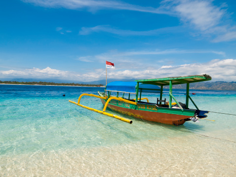 Gili Trawangan, Indonesia - August 22, 2007: Local style outrigger boat used for tours on Gili Trawangan island in Indonesia. Gili Trawangan is a popular destination for backpackers and increasingly for more upmarket tourists.