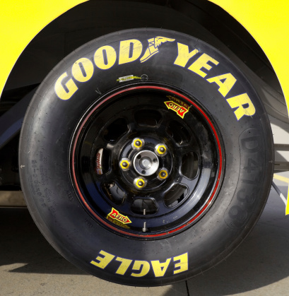 Charlotte, North Carolina, USA - November 22, 2011: Good Year Stock car racing tire.  Tire is jacked up and attached to a 2012 Stock car.