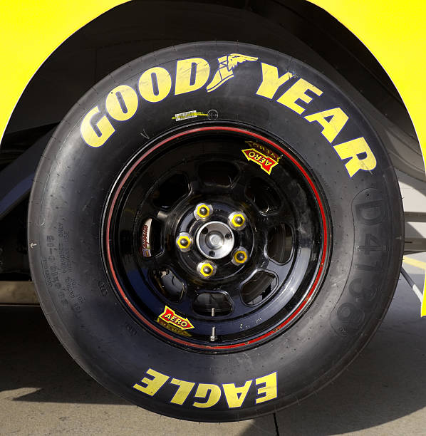 Good Year Racing tire Charlotte, North Carolina, USA - November 22, 2011: Good Year Stock car racing tire.  Tire is jacked up and attached to a 2012 Stock car. stock car stock pictures, royalty-free photos & images