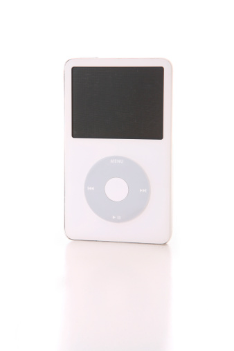 Madison, MS USA -January 6, 2011: A white classic 60 GB iPod from 2005 by AppleA standing, upright front view on a reflective surface with white background.