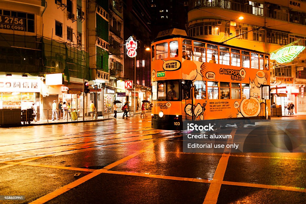 Tram in Hong Kong Hong Kong, China - September 25, 2011: Double decker tram driving in Waichan district in Hong Kong while people are walking on the street Asia Stock Photo
