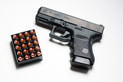 Carnation, WA, USA - February 11, 2012: Overall view of a Glock 30SF .45 caliber semi-automatic handgun produced by GLOCK Ges.m.b.H.of Austria, along with a tray of Hornady \