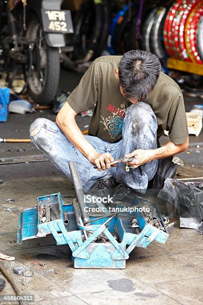 Repairing Motorbikes Stock Photo - Download Image Now - Adult, Adults Only, Asia