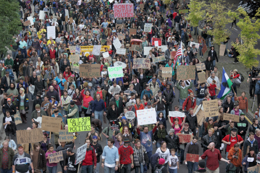 Portland, Oregon, USA - October 9, 2011:  Occupy Portland protesters march down NW Naito Parkway on their way to the camp site in Lownsdale Square and Chapman Square. Occupy Portland is one of the many organized events across the world protesting the disparity in wealth and the influence corporations have on governments. The first of these events was started in September in New York City and named Occupy Wall Street.