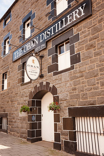 Oban Distillery Oban, UK - August 14, 2011: The entrance to the Oban Distillery in the west coast town of Oban in Argyll, Scotland. The distillery was built in 1794, before Oban existed as a town, and the town grew up around it. The distillery is currently owned by the Diageo organization. oban stock pictures, royalty-free photos & images