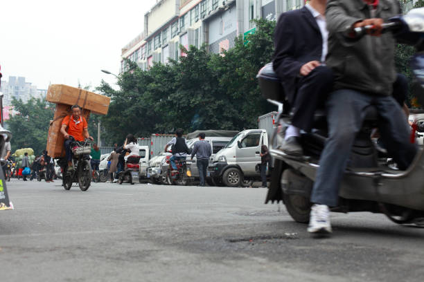 Chengdu,Sichuan Province,China- October 9,2011: one porter carrying loads and riding bike in the busy street.