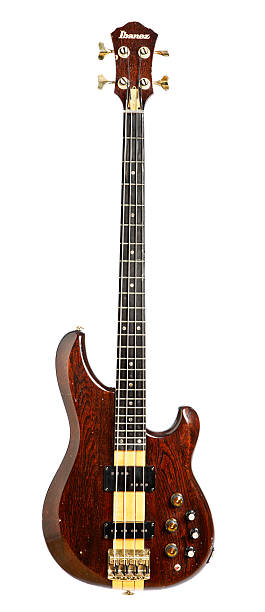 Ibanez Musician bass guitar isolated on white Cape Town, South Africa - March 30, 2009: A slightly battered  Ibanez Musician bass guitar made in 1983. This Japanese-made instrument is of neck-through construction and features active electronics. bass guitar stock pictures, royalty-free photos & images