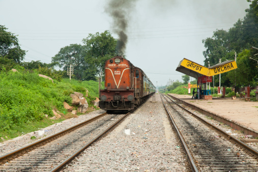 Orchha, India - August 23, 2011: Passenger train passing through the Orchha's Railwaiy station. Regional indian trains provide affordable public transportation around the whole country.