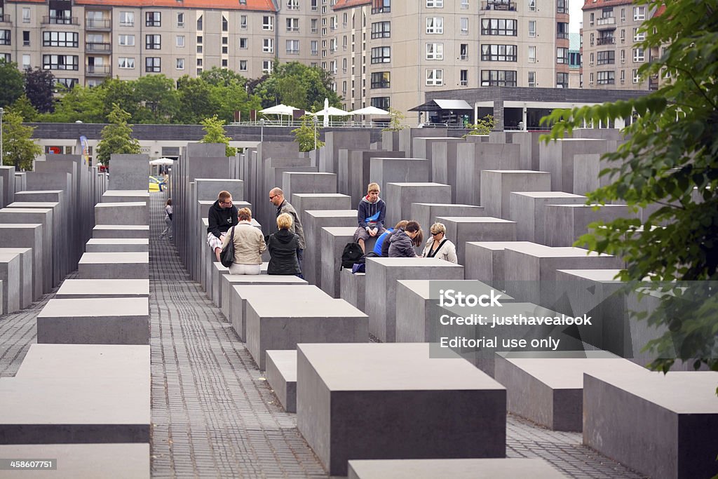 Visiting Holocaust memorial in Berlin Berlin, Germany - May, 29th 2011: Tourists and familys are visiting Holocaust memorial in Berlin. Holocaust memorial in Berlin dedicated to murdered European Jews in World War II. It was desigend by Peter Eisenmann and built in 2004. Berlin Stock Photo