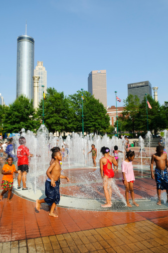 Atlanta, GA, USA - August 3, 2011: Children play at the Fountain of Rings at Centennial Olympic Park in downtown. The park was built for the 1996 Olympic games and continues to draw visitors, especially in summer.