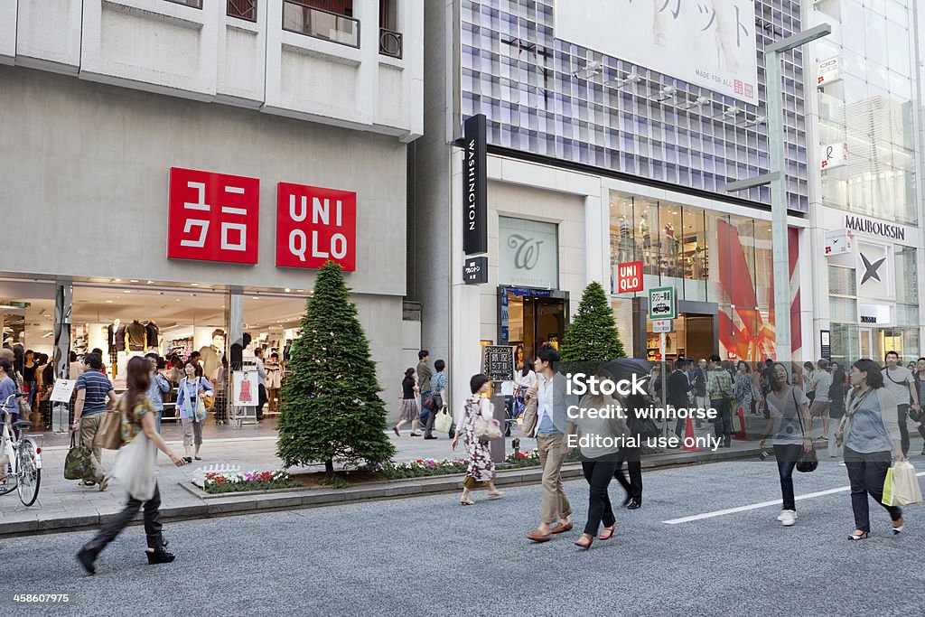 UNIQLO shop in Tokyo, Japan "Tokyo, Japan - June 4, 2011 : Pedestrians walk past a Uniqlo store in Ginza, Tokyo, Japan. This UNIQLO clothing store located at Ginza shopping district, it is the most expensive real estate price in Japan. Uniqlo chain is Asia\'s biggest clothing retailer." Uniqlo Stock Photo