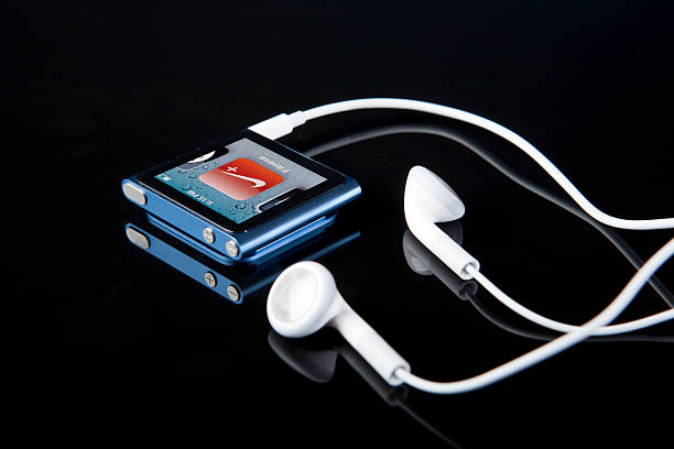 6th Generation Apple iPod Nano with Nike Fitness Program Portland, Oregon, USA - October 10, 2011: The new Apple iPod Nano 6th generation with Multi-Touch technology. Shown in blue with the Nike Fitness Program that helps record your work out progress. ipod nano stock pictures, royalty-free photos & images