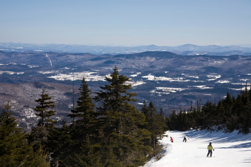 Warren, USA - March 20, 2011: Three alpine skiers take the Jester Trail down from the Summit of Sugarbush Mountain Resort in Vermont.