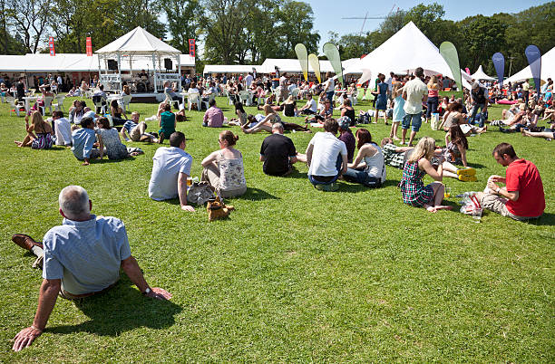 Edinburgh, Scotland, UK - 3rd July, 2011: People relaxing, chatting qand sampling the food and drink provided by exhibitors at the Taste of Edinburgh food festival in The Meadows.