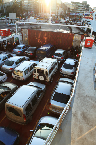 Istanbul, Turkey - November 5, 2009: Istanbulites waiting to disembark at Sirkeci IDO ferry terminal crossing Golden Horn along with their vehicles on car ferry service run by iDO Istanbul Fast Ferries Company, of Istanbul Metropolitan Municipality, on their way from Harem on Asian shore of Bosporus. Car ferries and sea busses are one of the most favorite ways of crossing Bosporus Strait of Istanbulites. Ferries are one of the various form of public transport for 13 million Istanbulites others being extensive bus network, light rail (light metro), metro, bus rapid transit, trams, nostalgic trams, suburban trains, Funicular, sea buses and taxis.