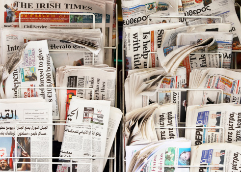 London, England - June 27, 2011: A display with international newspapers on the street, Soho, London.