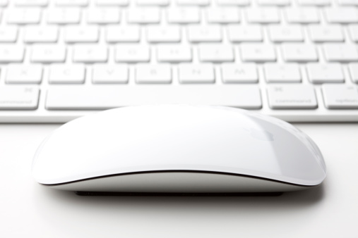 Belen, New Mexico, USA - August 16, 2011: A wireless Magic Mouse and full size U.S. aluminum Keyboard by Apple Inc. The Magic Mouse allows users to perform simple gestures across its smooth, seamless top.