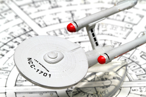 Vancouver, Canada - December 11, 2011: The Starship Enterprise from the Star Trek television franchise, against a background made from deckplans.  The model was made by Micro Machines, from Galoob and the deck plans were drawn by Franz Joseph.