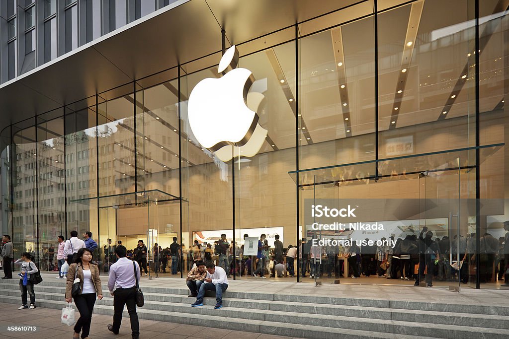 Apple Store in China Shanghai, China - October 12, 2011:  Glass entrance to the Apple Store at Nanjing road opened on the September 23, 2011. Many people inside and outside the shop. Editorial Stock Photo