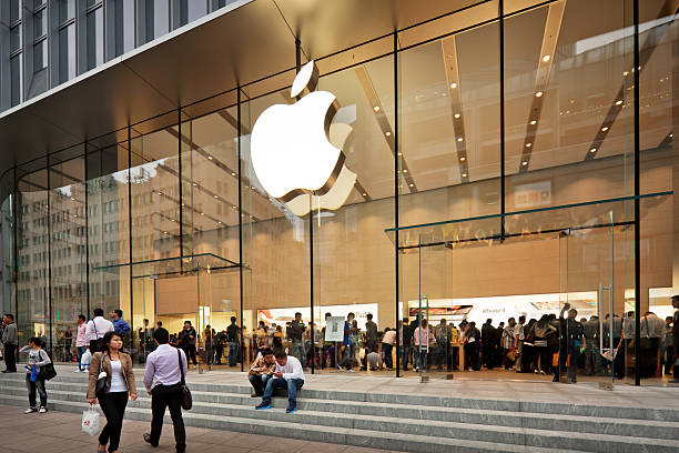 Apple Store in China Shanghai, China - October 12, 2011:  Glass entrance to the Apple Store at Nanjing road opened on the September 23, 2011. Many people inside and outside the shop. editorial stock pictures, royalty-free photos & images