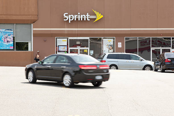 Sprint Yonkers, New York, USA - July 4, 2011: A person standing next to a Sprint store in Central Plaza Shopping Center in Westchester County. Sprint is a wireless cell phone carrier and served more than 49 million customers last year. sprint nextel stock pictures, royalty-free photos & images