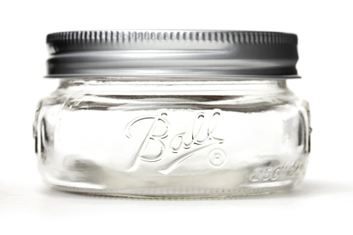 Belen, New Mexico, USA - April 27, 2012: A glass half-pint Ball canning jar. Ball Corporation was founded in 1880 and is a provider of metal packaging for beverages, foods and household products.
