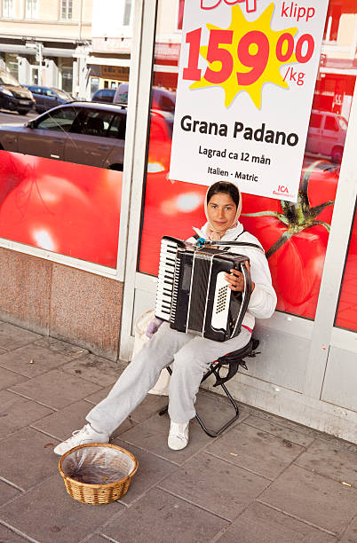 young woman playing accordion on the sidewalk. - dragspel ute sverige bildbanksfoton och bilder