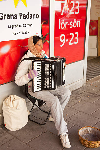 young woman playing accordion on the sidewalk. - dragspel ute sverige bildbanksfoton och bilder
