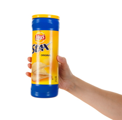 Chillicothe, Ohio, USA - July 5th, 2011: Woman\'s hand holding Lays Stax potato chips, manufactured for Frito-Lay, Inc. Studio isolated on a white background.