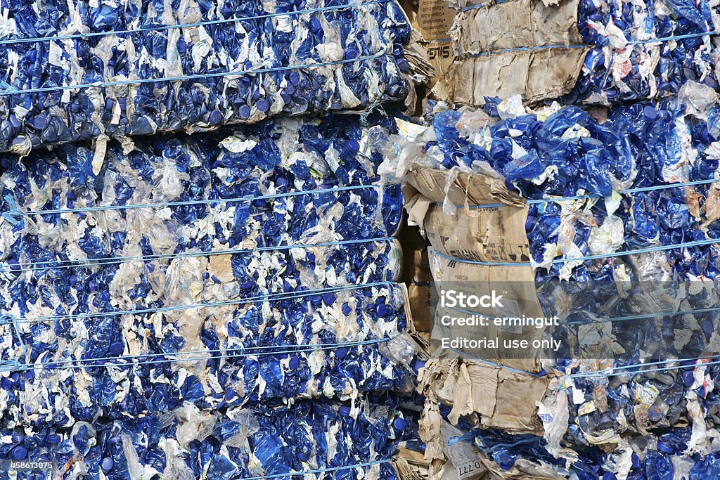 Blue plastic bottles packed for recycling Celje, Slovenia - March 13, 2011: Blue plastic bottles packed for recycling stored in recycling facility. Compressed in cube like shape for easier handling. Close up photo. Accidents and Disasters Stock Photo