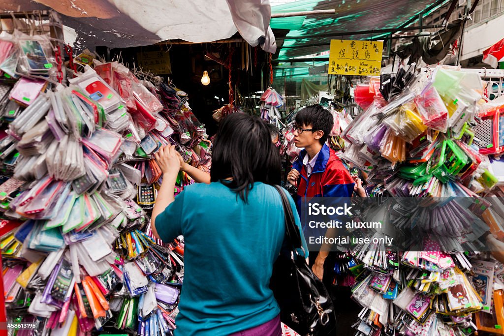Mobile phone cases in market stall Hong Kong, China - October 5, 2011: People buying mobile phone cases in market stalls in Shim Shui Po in Hong Kong Asia Stock Photo