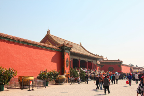 Beijing, China - April 30, 2010: Tourists walking through the forbidden city on a warm spring day.