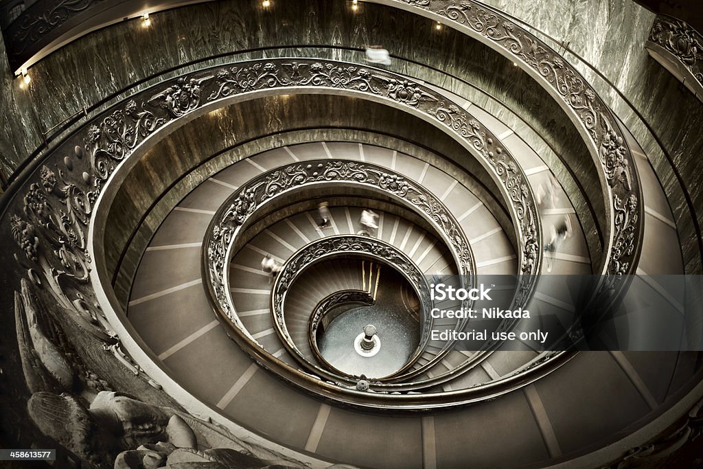 Stairway in Vatican Museum Rome, Italy - 11 September, 2010: The old stairway inside the Vatican museum with moving people in Rome, Italy Spiral Stock Photo