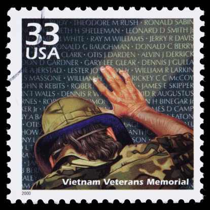 Sacramento, California, USA - March 23, 2011: A 2000 USA postage stamp with an illustration of a man touching the Vietnam Veterans Memorial wall. Designed by Maya Lin, the memorial was dedicated in 1982. The stamp was designed by Carl Herrman with an illustration by Robert Rodriguez.