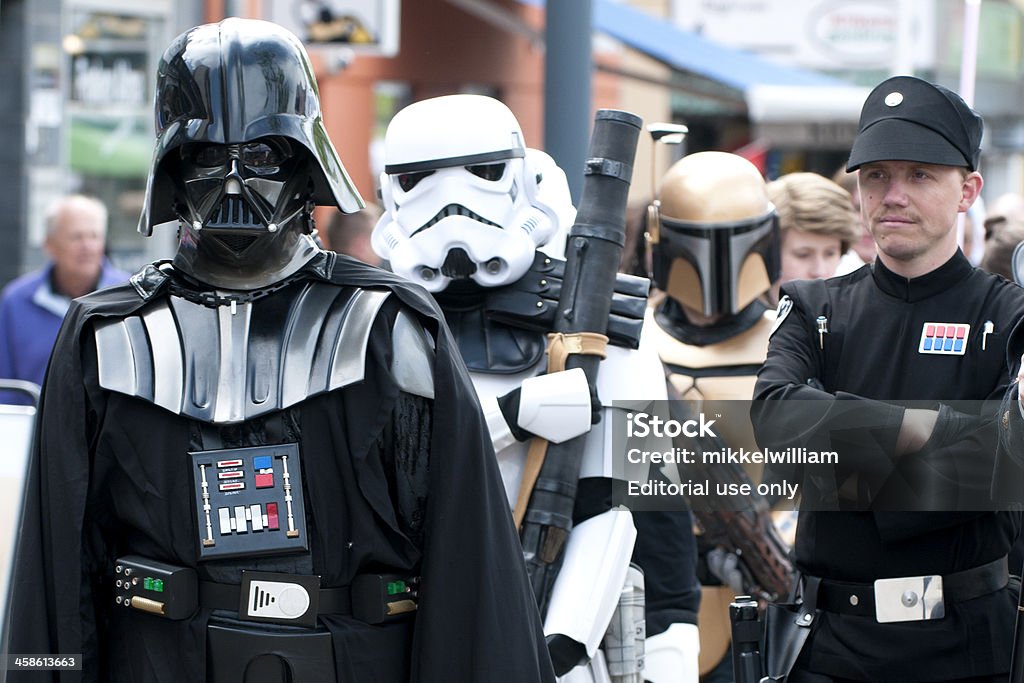 Darth Vader from Star Wars Taastrup, Denmark - May 28th, 2011: Darth Vader from Star Wars is taking a walk in his legendary black suit. Stormtroopers are walking behind him. It is all part of a parade made by a group of Danish movie freaks. Some of the real actors from the Star Wars movies made by George Lucas are also taking part in the parade. Star Wars Stock Photo