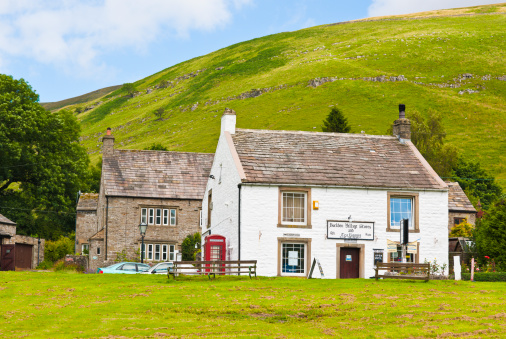 Kettlewell, United Kingdom - August 5, 2011: Whitewashed Buckden Village Stores with stone roof in the Yorkshire Dales where Yorvale ice cream is sold