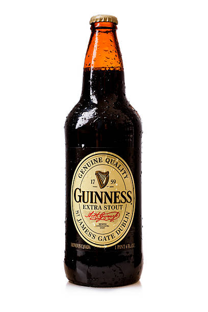 Guinnes extra stout "Miami, USA - June 17, 2011: Bottle of a guinnes extra stout beer with water drops. Guinnes is a popular Irish Beer and is one of the most successful brands worldwide." guinnes stock pictures, royalty-free photos & images