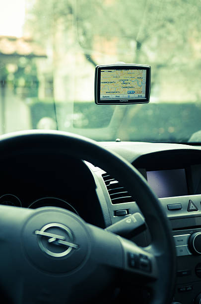 TomTom navigator inside a Opel car Florence, Italy - March 19, 2011: Tom Tom XXL (Europe Version) inside an Opel Zafira car. The gps navigator show the London Map. TomTom is a Dutch company that makes satellite navigation systems for automobiles, motorcycles, handhelds and smartphones. It is the leading supplier of navigation systems in Europe with offices around the world. guidanc stock pictures, royalty-free photos & images