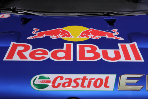Frankfurt, Germany - September 25, 2011: The logo of Red Bull Racing Team with two typical bulls fighting each other is attached on the blue metallic hood of a Volkswagen rally car version which is being displayed on the world\'s biggest automobile exhibition, the IAA in Frankfurt, Germany. Red Bull Racing is actually extremly popular in Germany because Formular One World Champion from Red Bull team, Sebastian Vettel, lives just a few Kilometers away from Frankfurt. Besides Formula One, Red Bull also runs a rally team. Originally Red Bull is the manufacturer of a non-alcoholic Energy drink. Castrol is the supplier of the engine oil and thus a team sponsor.