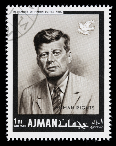 Sacramento, California, USA - December 24, 2008: A 1968 Ajman postage stamp with a portrait of US President John F Kennedy. The stamp is part of the Ajman human rights series created in memory of Martin Luther King.