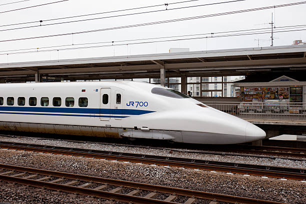 Odawara, Japan - May 31, 2011 : Japan Railway Co. Shinkansen bullet train parked at Odawara Station. This station is located in 1-chome, Sakaecho, Odawara, Japan. It is a 700 Series Shinkansen train. Some passengers are inside the train and on the platform.