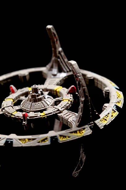 Askew in Space Vancouver, Canada - November 13, 2011: A model of Deep Space Nine from the Star Trek television series, on a black background. The model was made by the Micro Machines division of the Galoob toy company. star trek characters stock pictures, royalty-free photos & images