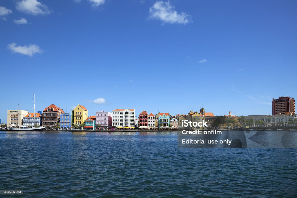 Willemstad, Curacao "Willemstad, Curacao - March 7, 2011: The historic Punda district waterfront. The classic Dutch architecture has earned the area UNESCO World Heritage Site status." Antilles Stock Photo