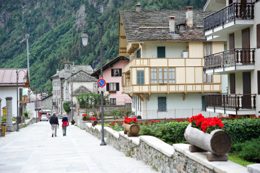 Alagna Valsesia,  Italy - August 5, 2010: couple in Via Centro, the main walking avenue in the turistic alpine town.